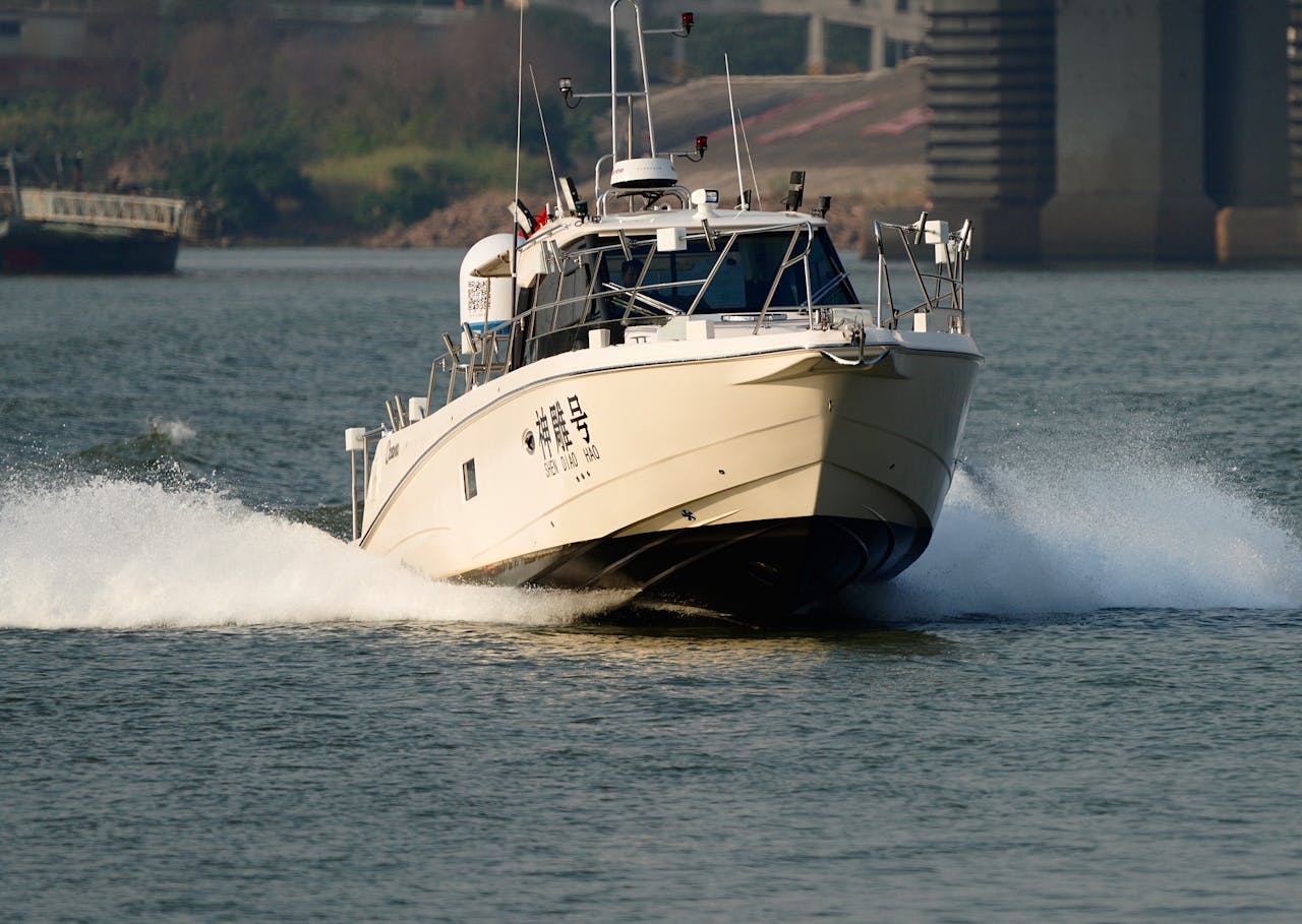 A powerful motorboat speeding through calm waters in an outdoor setting.