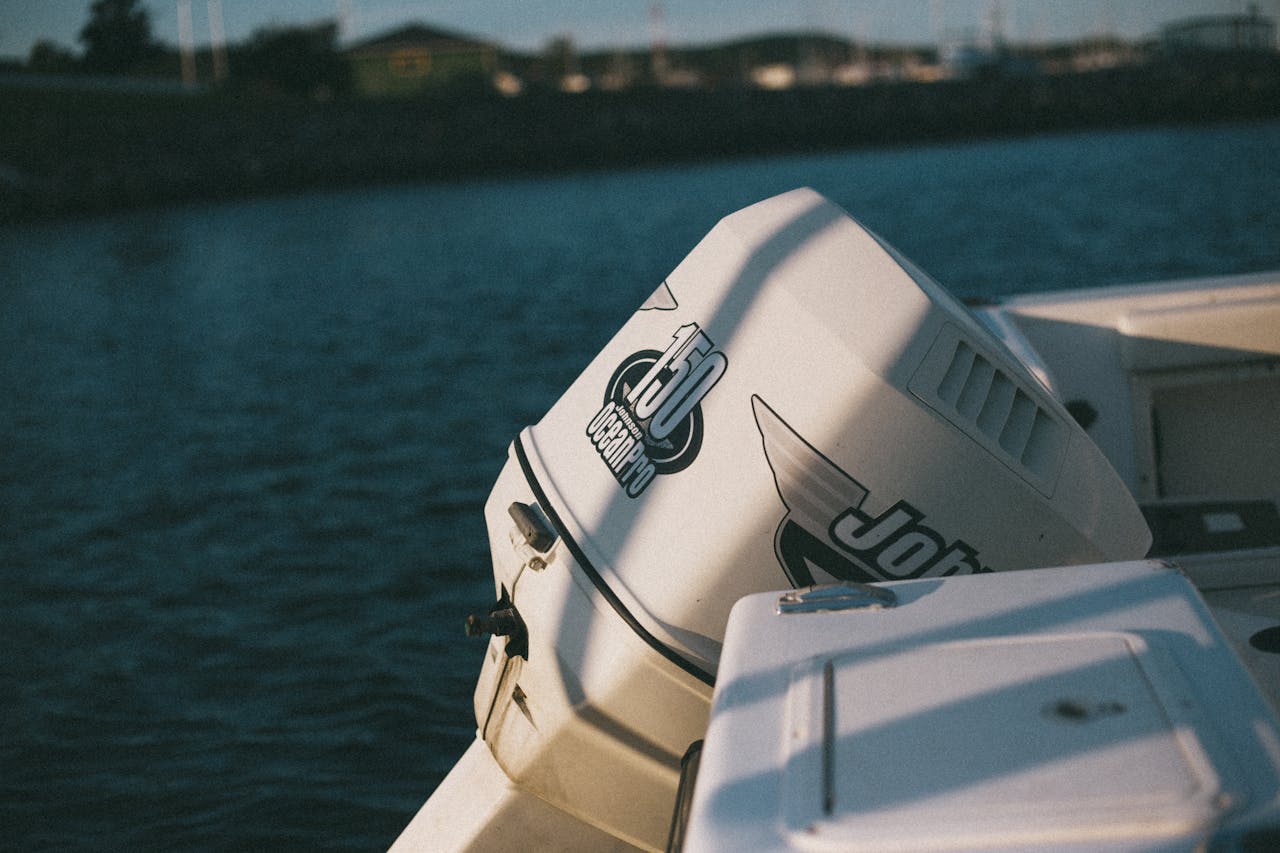 Close-up of a motorboat engine in a serene harbor setting, perfect for nautical themes.